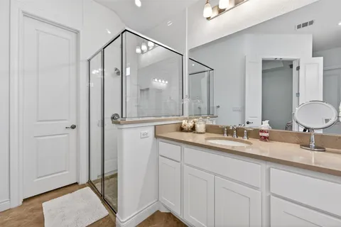 a bathroom with a double vanity sink and mirror