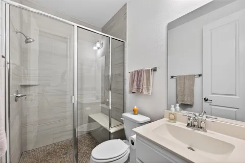 a bathroom with a sink toilet and shower
