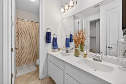 a bathroom with a sink vanity mirror and toilet