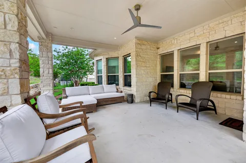 a building outdoor space with patio furniture and potted plants
