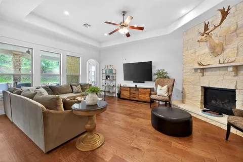 a living room with furniture a fireplace and a flat screen tv