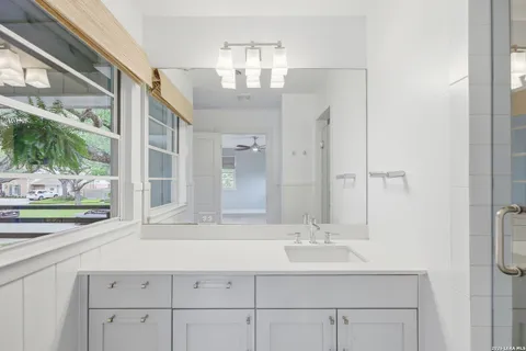 a bathroom with a sink double vanity and a mirror
