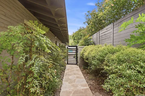 a pathway of a house with flower garden