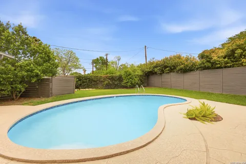 a view of a swimming pool with an outdoor space and seating area