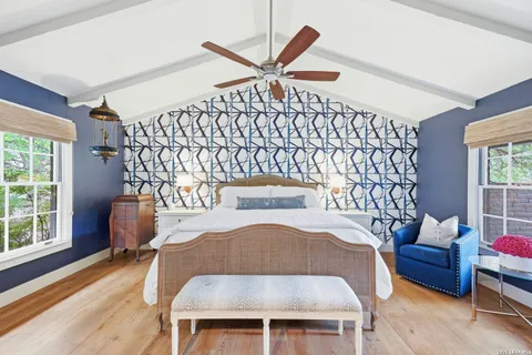 a bedroom with a bed and a chair