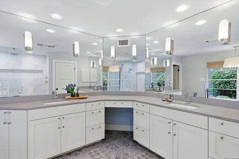 a kitchen with a sink dishwasher a stove and cabinets