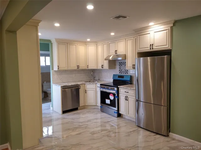 a kitchen with a refrigerator and a stove top oven