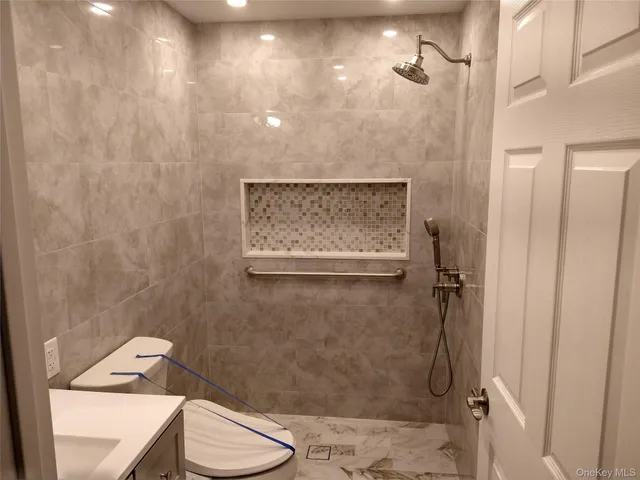 a bathroom with a toilet and a shower