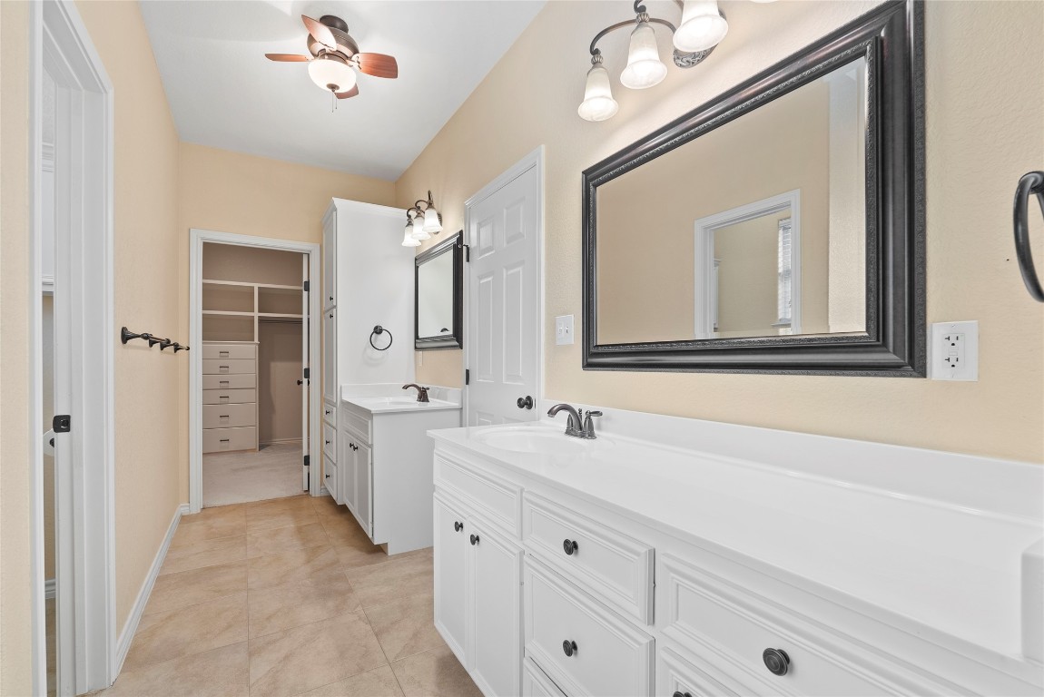 330 Arbors Circle Elgin, TX 78621 - Photo 18 of 39 Bathroom featuring tile patterned floors, a walk in closet, ceiling fan, and vanity