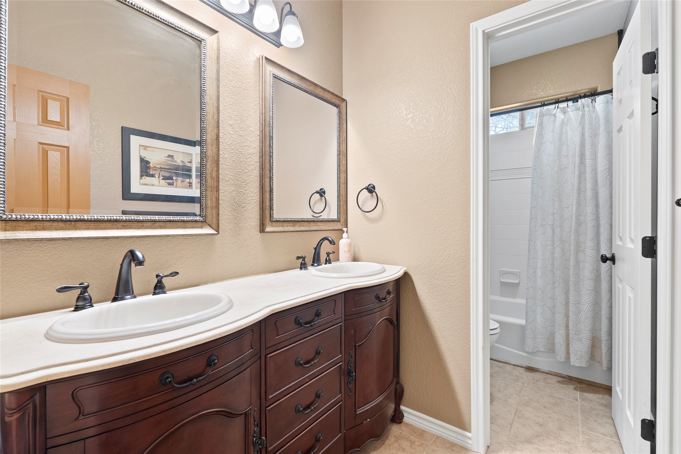 330 Arbors Circle Elgin, TX 78621 - Photo 21 of 36 a bathroom with a double vanity sink and a mirror