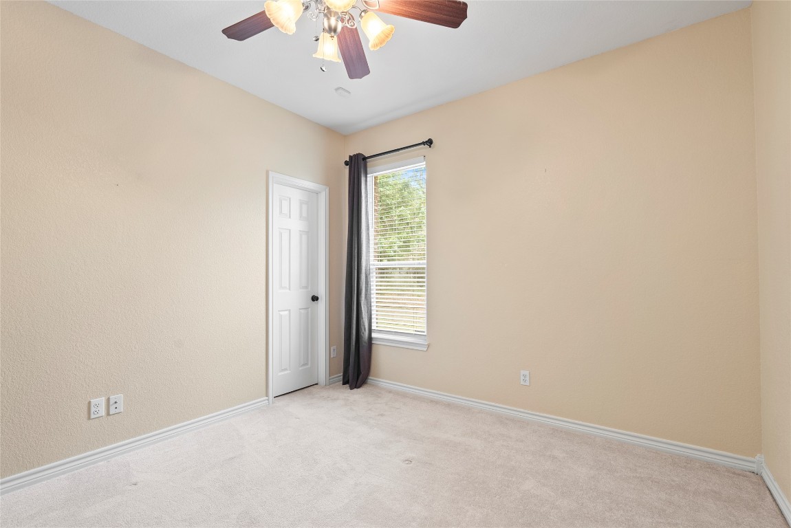 330 Arbors Circle Elgin, TX 78621 - Photo 23 of 39 Spare room featuring baseboards, ceiling fan, and light carpet