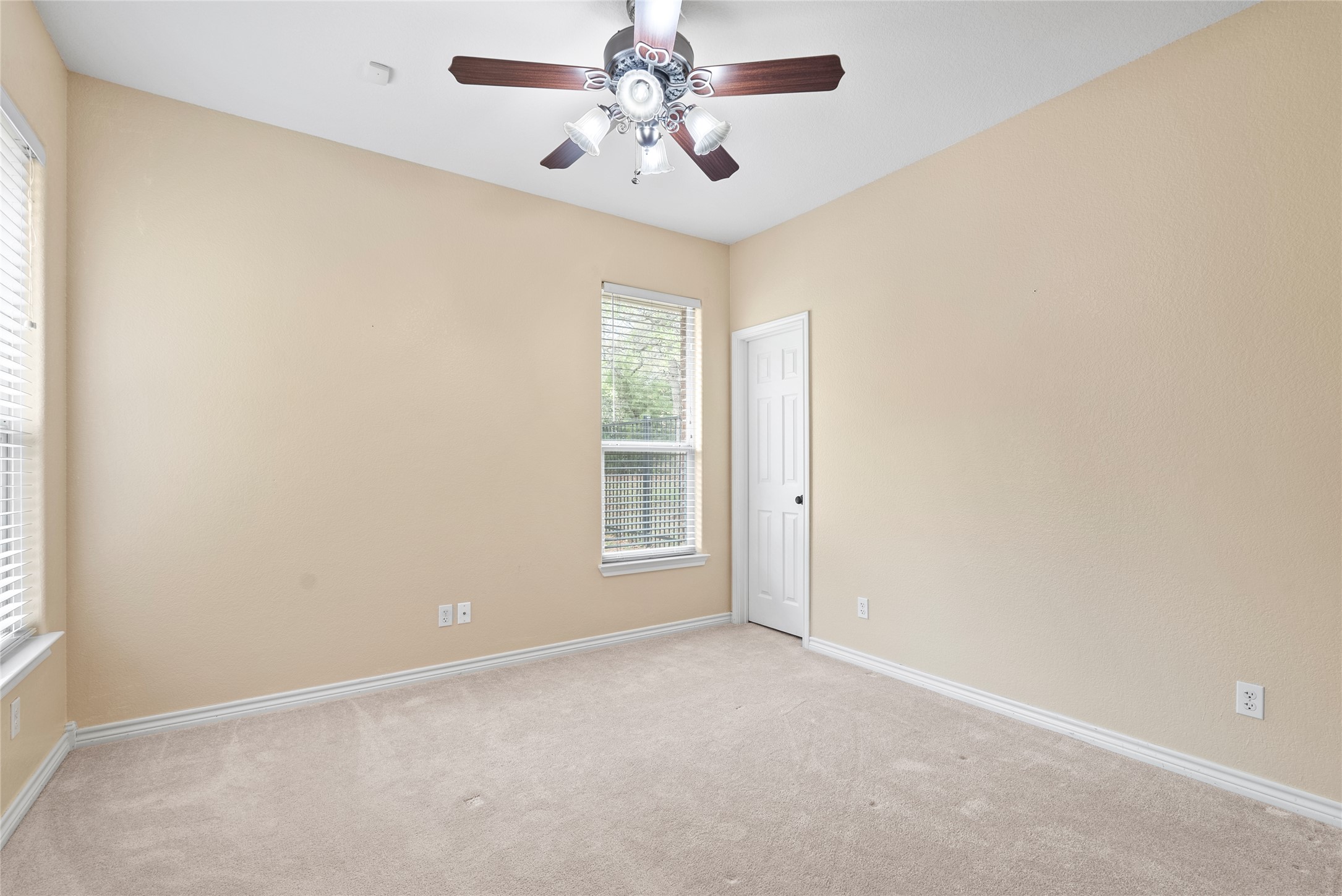 330 Arbors Circle Elgin, TX 78621 - Photo 23 of 36 an empty room with windows and fan