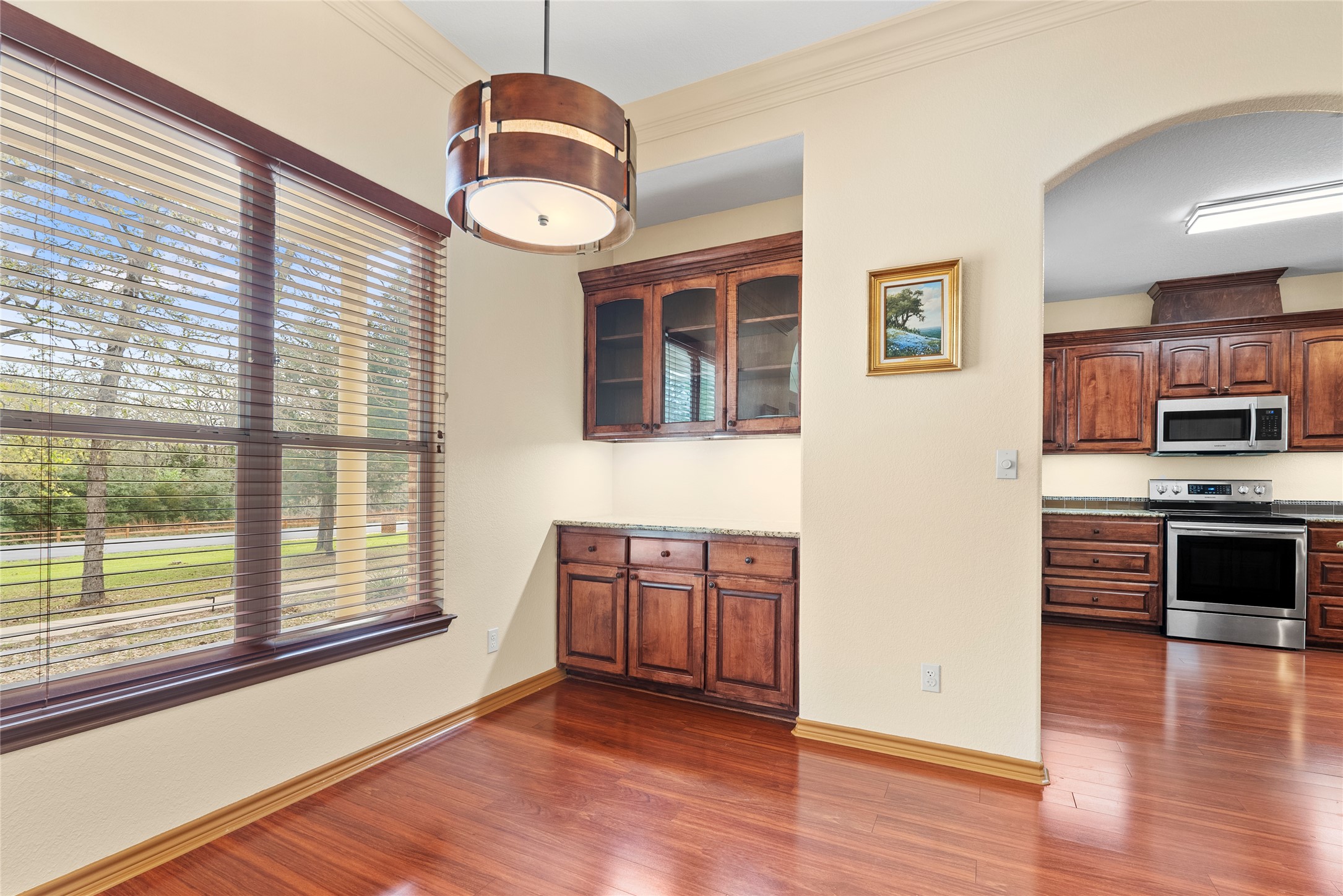 330 Arbors Circle Elgin, TX 78621 - Photo 25 of 36 a view of a kitchen with a stove wooden cabinets and dining space