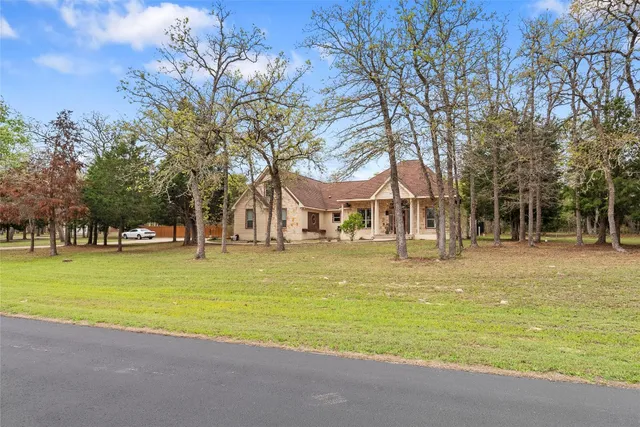 a view of a swimming pool with a house in the background
