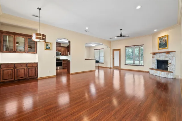 a view of a kitchen with furniture and wooden floor