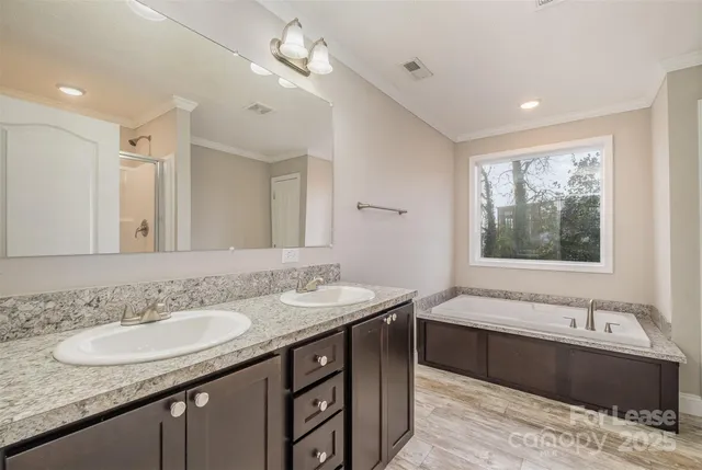 a bathroom with a granite countertop sink mirror and bathtub