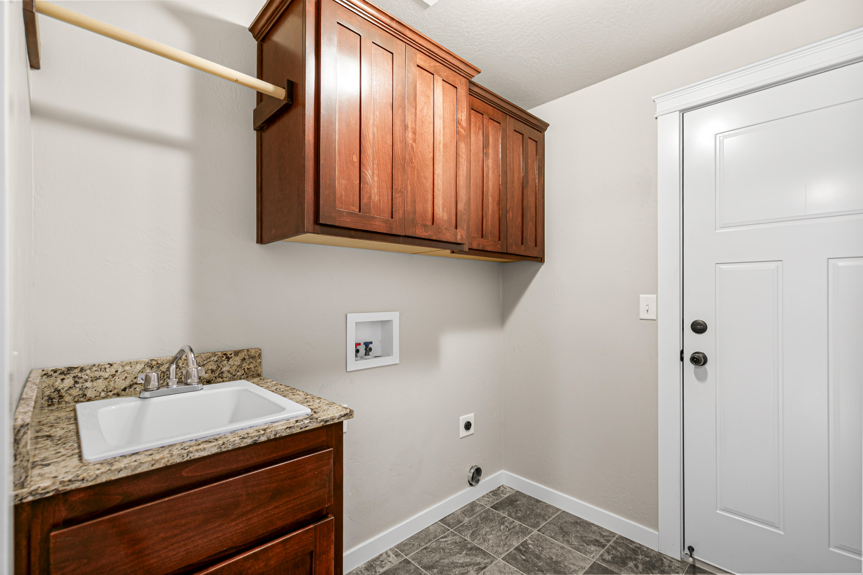 3288 Grant Road Central Point, OR 97502 - Photo 20 of 30 Laundry room with sink and storage.