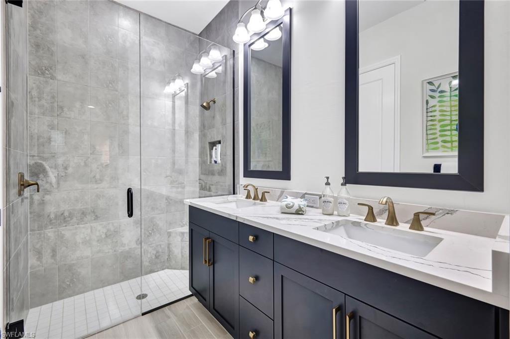 7142 Cayo Coco Lane Naples, FL 34113 - Photo 9 of 17 a bathroom with a double vanity sink mirror and double