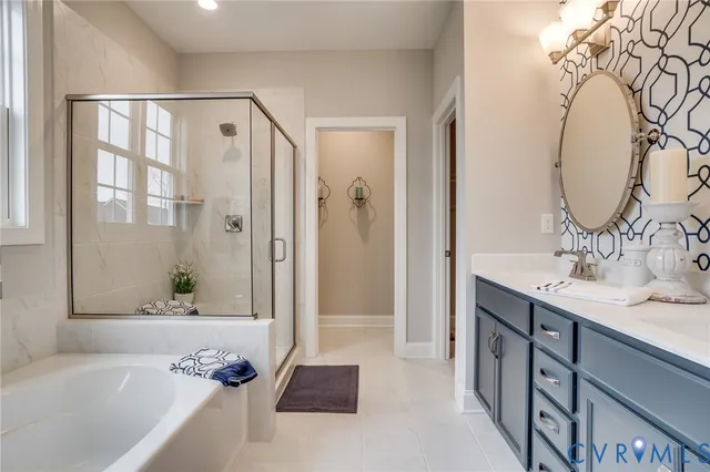 a bathroom with a tub sink and mirror