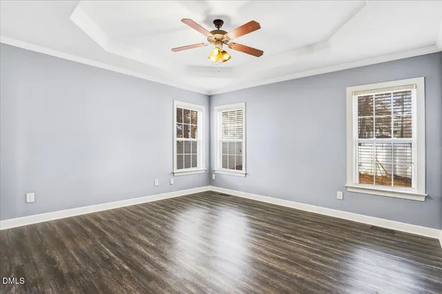 a view of an empty room and window and wooden floor