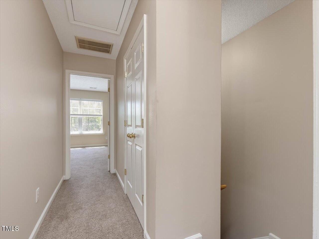 5402 Patuxent Drive Raleigh, NC 27616 - Photo 11 of 27 a view of a hallway with wooden floor