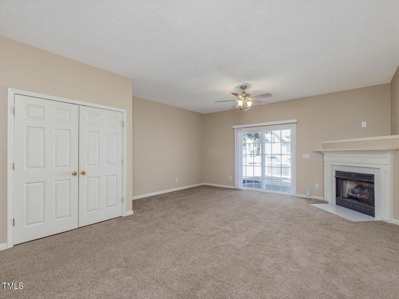 5402 Patuxent Drive Raleigh, NC 27616 - Photo 3 of 27 a view of an empty room with a fireplace and a window