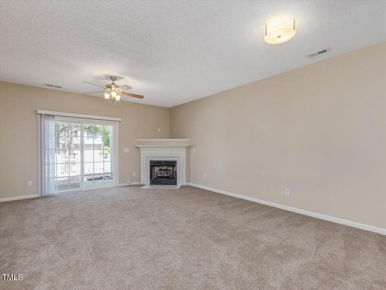 5402 Patuxent Drive Raleigh, NC 27616 - Photo 4 of 27 an empty room with chandelier fan and windows