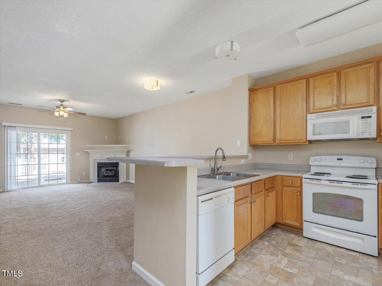 5402 Patuxent Drive Raleigh, NC 27616 - Photo 27 of 27 a kitchen with stainless steel appliances granite countertop a stove sink and cabinets