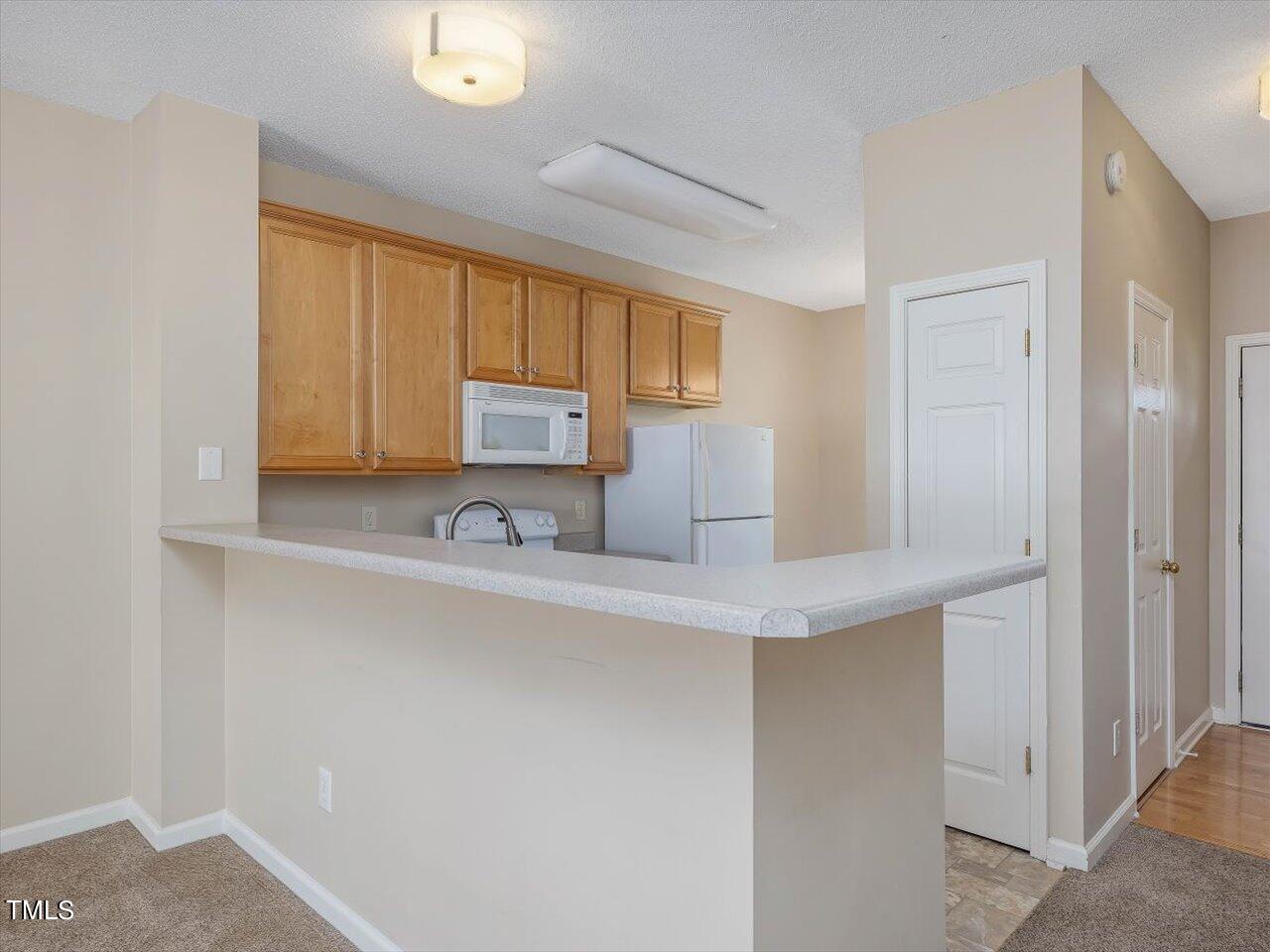 5402 Patuxent Drive Raleigh, NC 27616 - Photo 5 of 27 a kitchen with a sink cabinets and window
