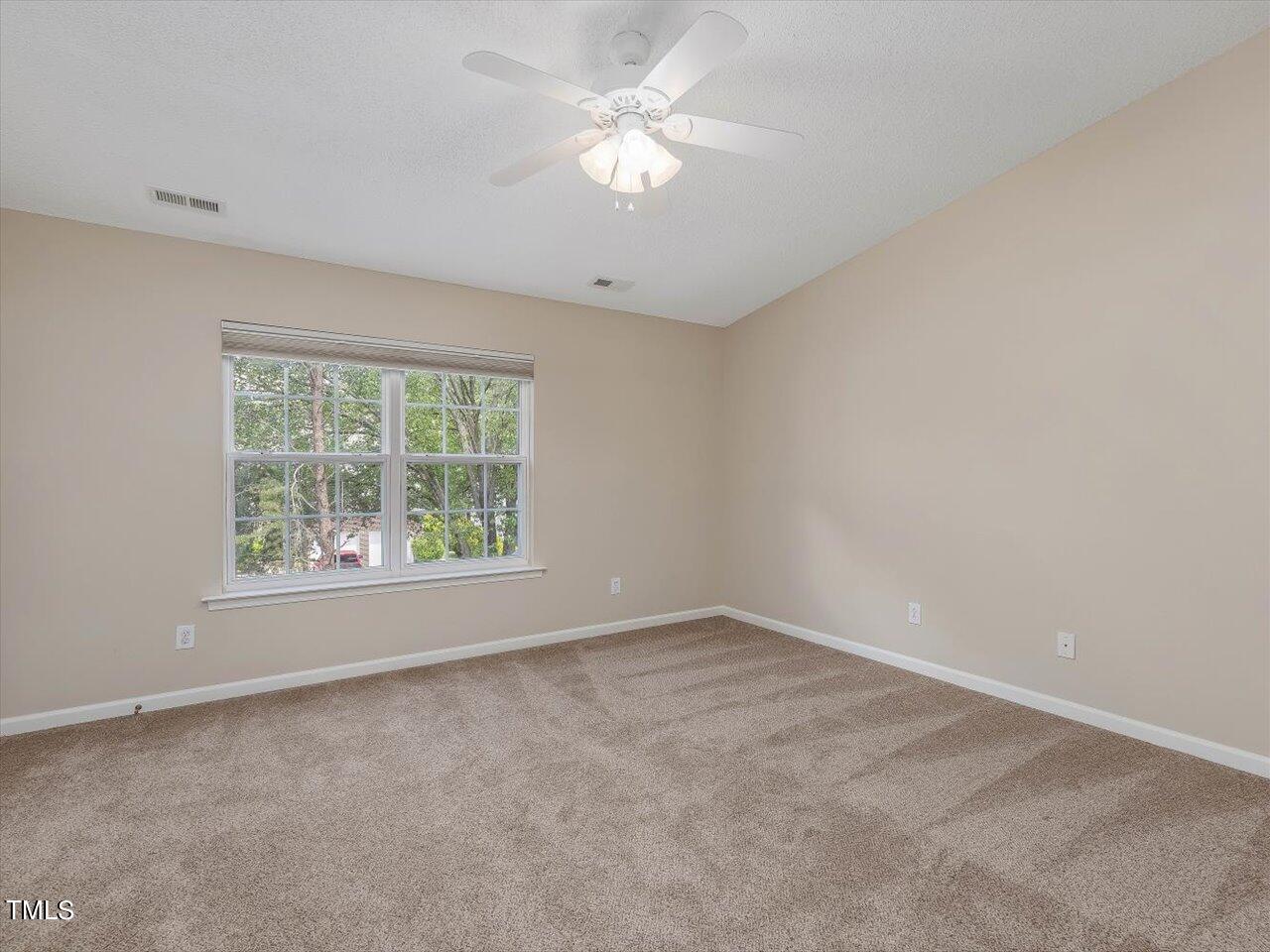 5402 Patuxent Drive Raleigh, NC 27616 - Photo 9 of 27 an empty room with a window and a fan