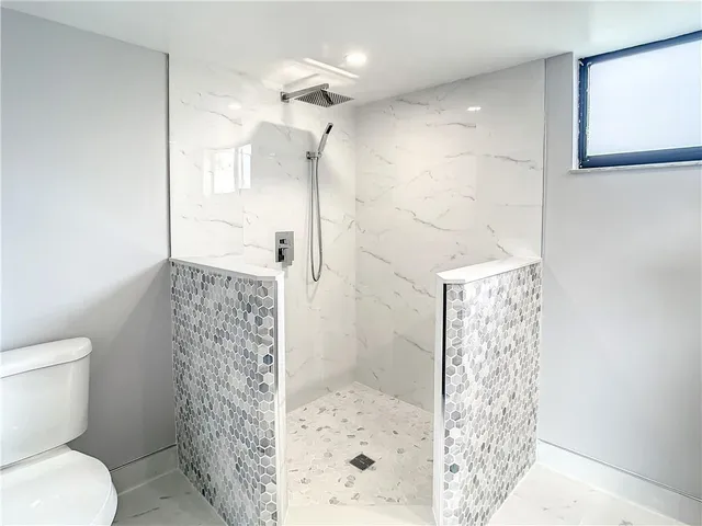 a bathroom with a shower toilet and a shower