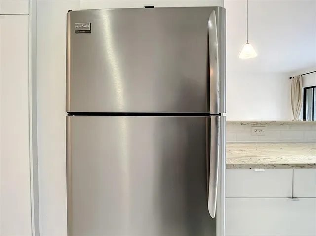 a view of a refrigerator in kitchen
