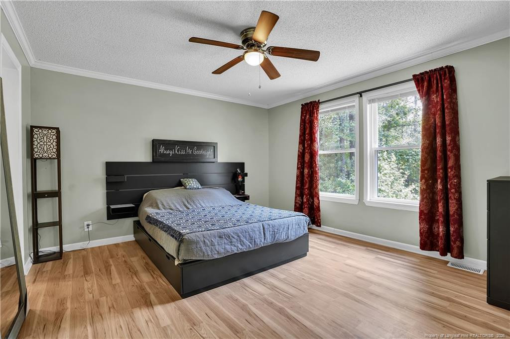 8155 Arabia Road Lumber Bridge, NC 28357 - Photo 20 of 30 a bedroom with a bed and a large window