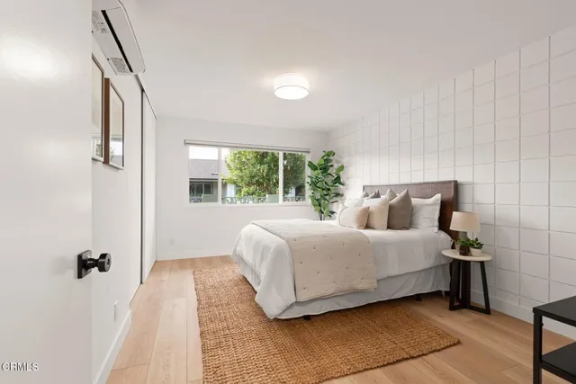 a bedroom with a large bed and a window