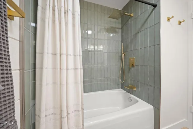 a view of a room with wooden floor and a white wall