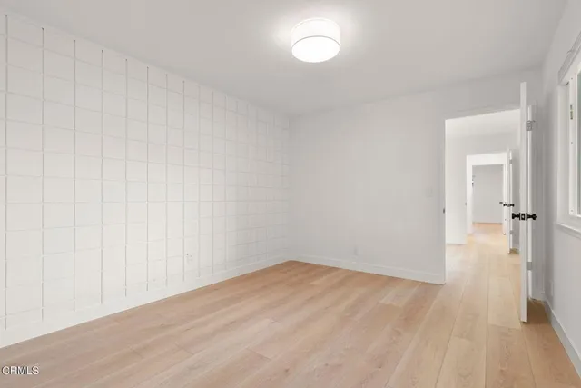 a bathroom with a shower a mirror and a sink