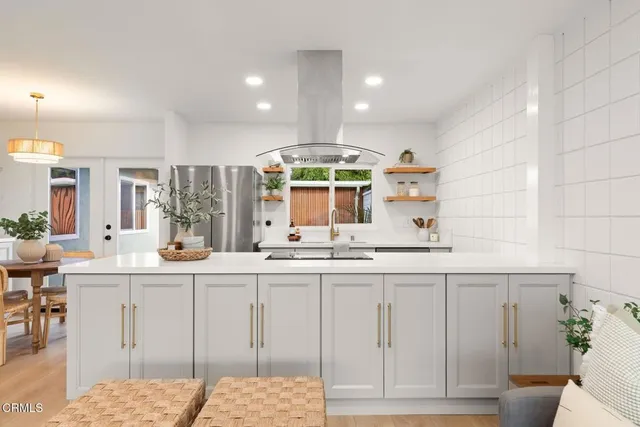 a kitchen with kitchen island granite countertop a sink and cabinets