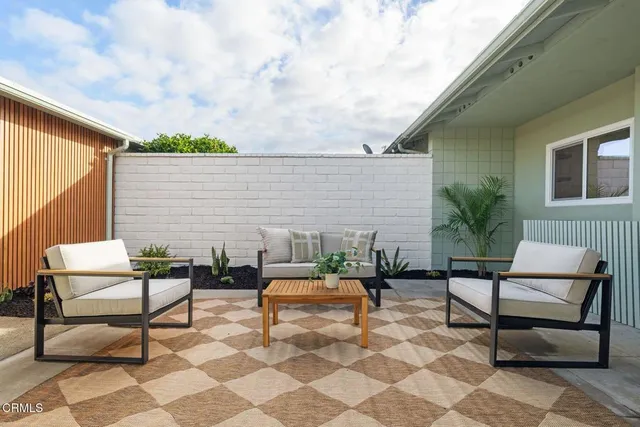 a outdoor space with a couch and a potted plant