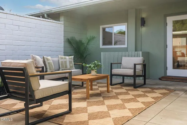 a outdoor living space with furniture and a potted plant