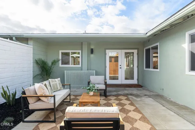 a view of a patio with table and chairs and potted plants