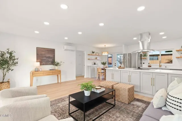 a living room with furniture and view of kitchen