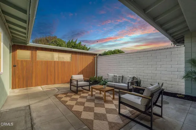 a view of a patio with chairs and a table