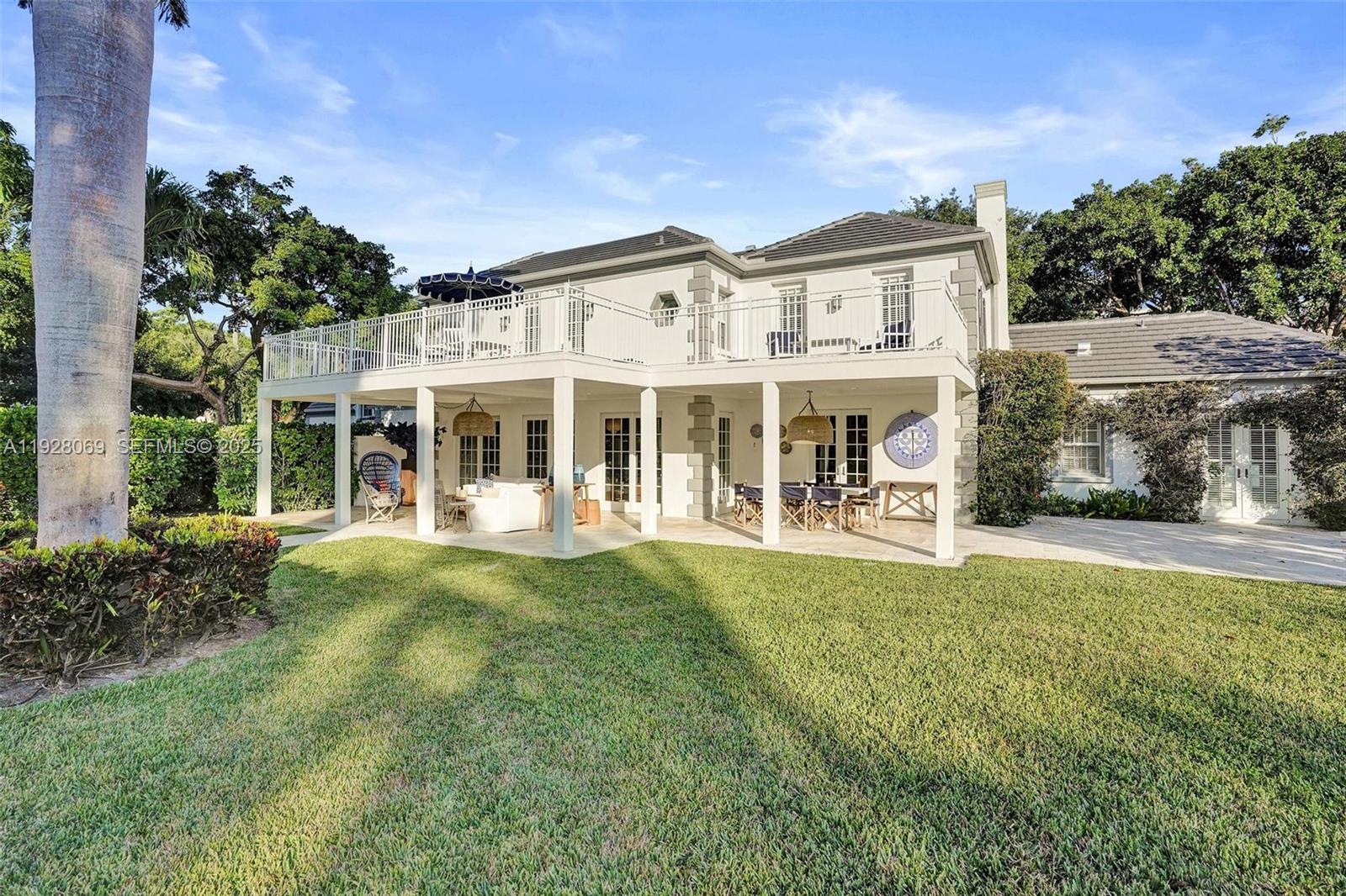 1281 Banyan Road Boca Raton, FL 33432 - Photo 16 of 69 a view of a house with a yard and sitting area