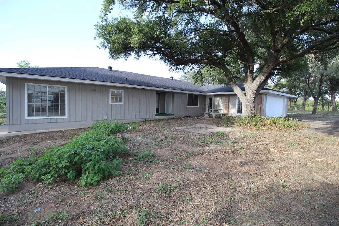 a front view of house with yard and trees
