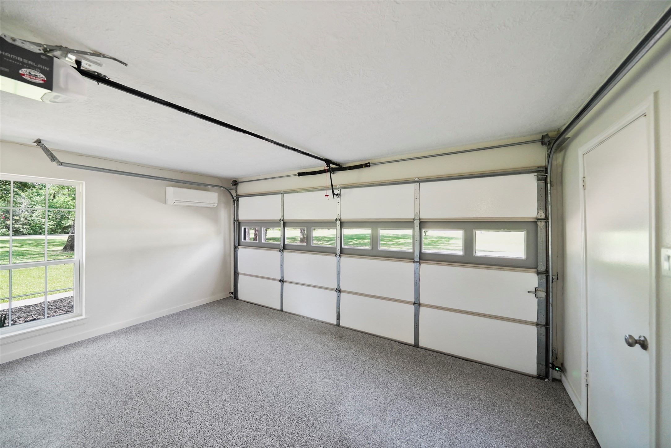 14443 Lyric Road Conroe, TX 77302 - Photo 37 of 49 Storage area that was once a garage. Has new door opener and is under its own AC. Perfect man-cave or she-shed.