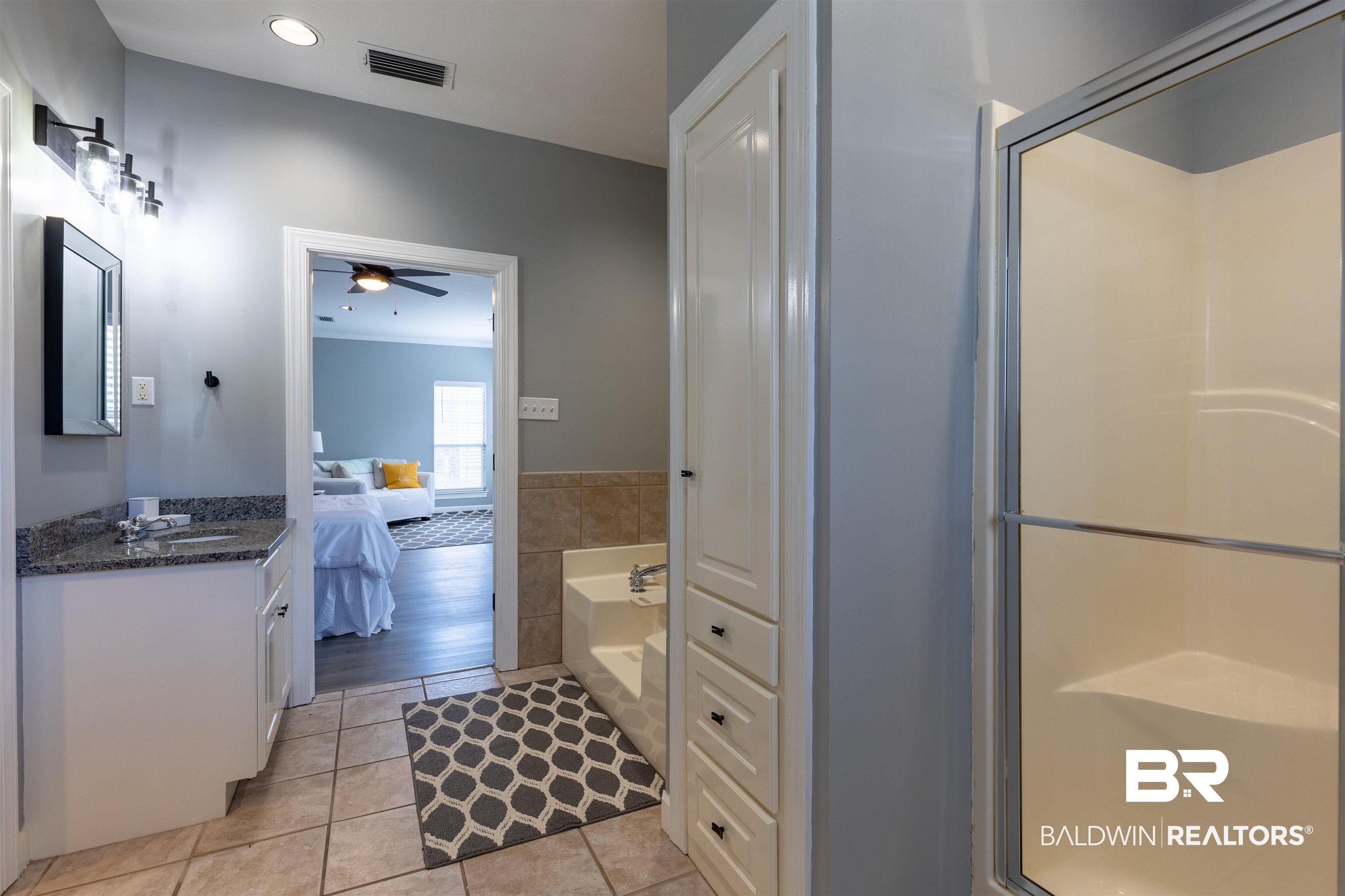 6436 Cherry Ridge Court West Mobile, AL 36695 - Photo 11 of 26 Bathroom with ensuite bathroom, visible vents, tile patterned floors, and a stall shower