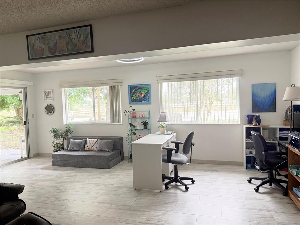 9394 Southwest 97th Lane, Unit A Ocala, FL 34481 - Photo 12 of 22 a view of a livingroom with workspace and a window