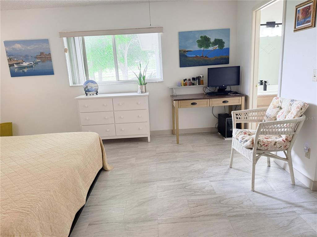 9394 Southwest 97th Lane, Unit A Ocala, FL 34481 - Photo 14 of 22 a room with a bed and a desk