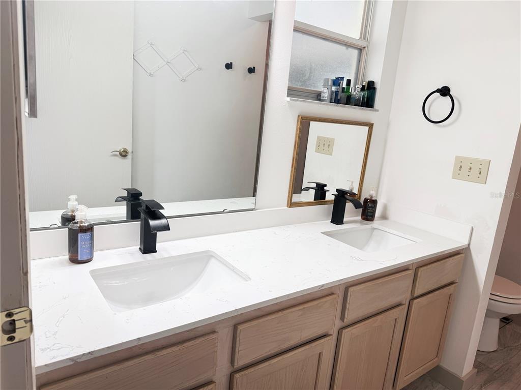 9394 Southwest 97th Lane, Unit A Ocala, FL 34481 - Photo 15 of 22 a bathroom with a sink and a mirror