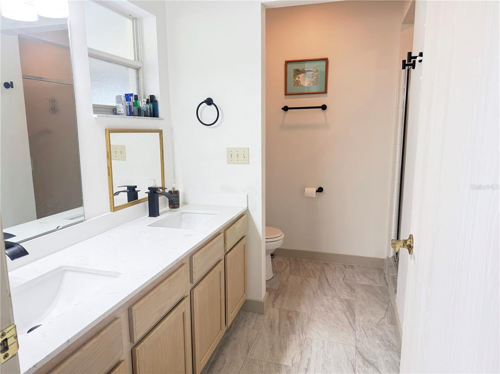 9394 Southwest 97th Lane, Unit A Ocala, FL 34481 - Photo 16 of 22 a bathroom with a sink and a mirror